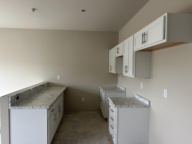 W194N16740 Eagle Dr Unit 1, Jackson, WI 53037 - kitchen featuring light carpet, white cabinetry, and light countertops