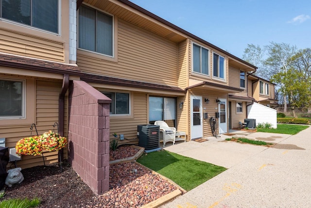 back of property featuring a patio area and central AC