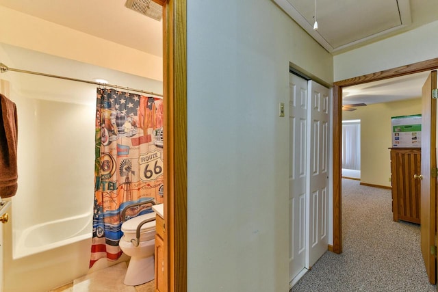 hallway featuring baseboards and visible vents