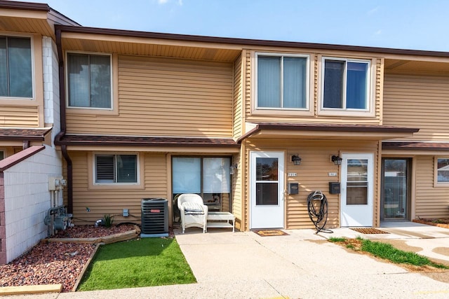 view of front of house with a patio and central AC