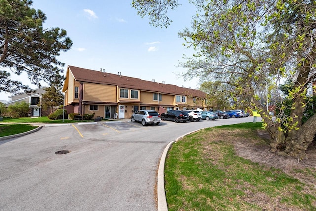 view of property featuring uncovered parking