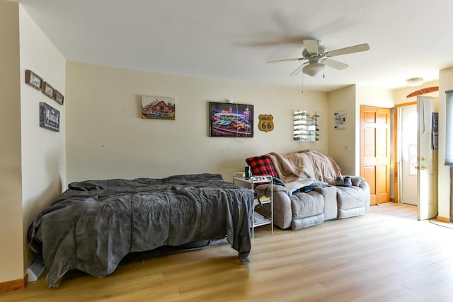 bedroom with a ceiling fan and light wood-style flooring