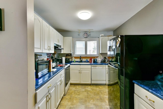 kitchen featuring a sink, dark countertops, black appliances, and under cabinet range hood
