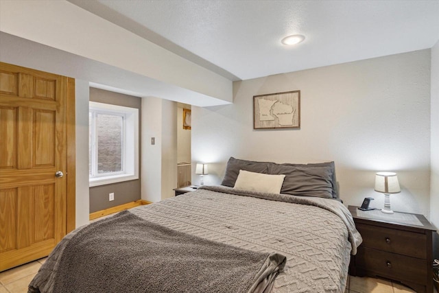 bedroom with light tile patterned floors