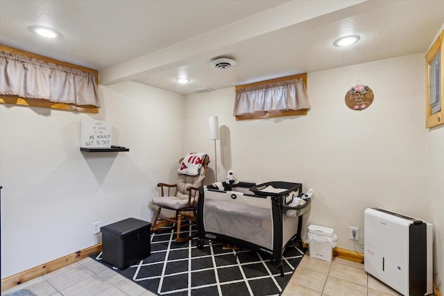interior space featuring recessed lighting, baseboards, tile patterned floors, and visible vents
