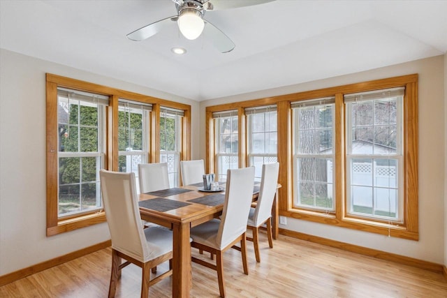dining space featuring baseboards, a ceiling fan, and light wood-style flooring
