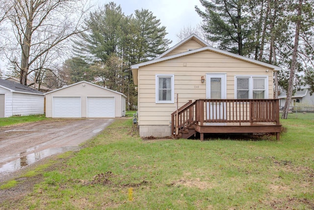 view of front of house featuring a garage, an outdoor structure, a wooden deck, and a front yard
