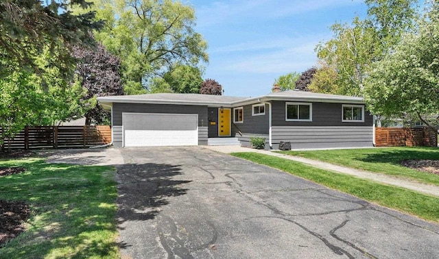 632 N Harrison St, Stoughton, WI 53589 - view of front of property featuring asphalt driveway and a garage