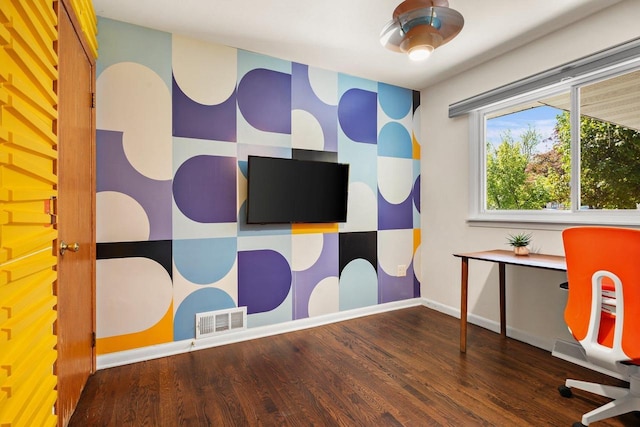 632 N Harrison St, Stoughton, WI 53589 - recreation room with wood finished floors, baseboards, an accent wall, and wallpapered walls
