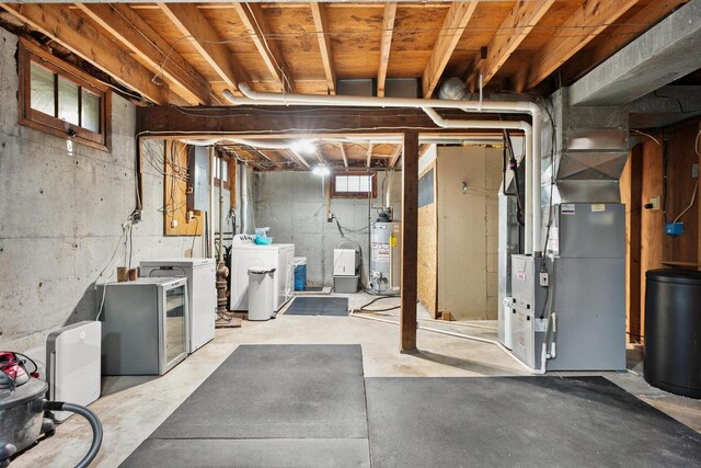 632 N Harrison St, Stoughton, WI 53589 - below grade area with washer and clothes dryer, gas water heater, heating unit, and refrigerator