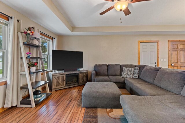 living room featuring a ceiling fan and wood finished floors