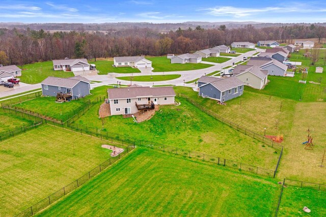drone / aerial view featuring a residential view and a forest view
