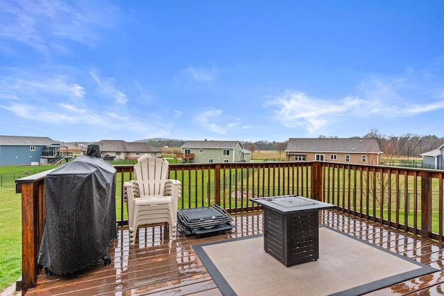 deck with a yard and a residential view