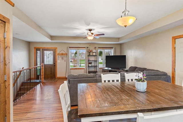 dining area featuring baseboards, ceiling fan, and hardwood / wood-style floors