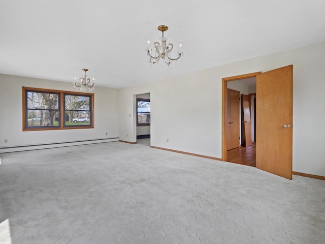 carpeted spare room with an inviting chandelier, baseboards, and a baseboard heating unit