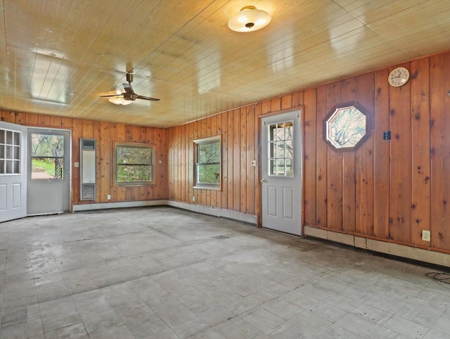 interior space with a healthy amount of sunlight, wood ceiling, and a ceiling fan