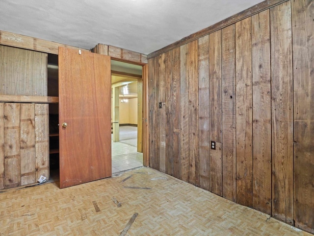 unfurnished bedroom with wooden walls