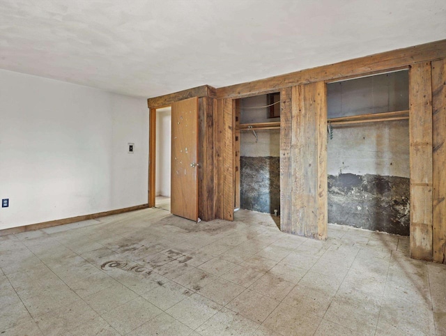 unfurnished bedroom featuring multiple closets and tile patterned floors