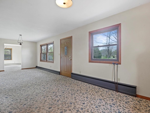 carpeted entrance foyer featuring baseboards, a baseboard heating unit, and a baseboard radiator