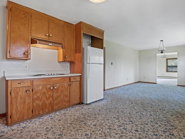 kitchen featuring freestanding refrigerator, baseboards, under cabinet range hood, and electric stovetop