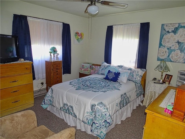 carpeted bedroom featuring a ceiling fan and baseboard heating