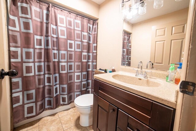 712 Frank St, Darlington, WI 53530 - bathroom featuring curtained shower, vanity, toilet, and tile patterned floors