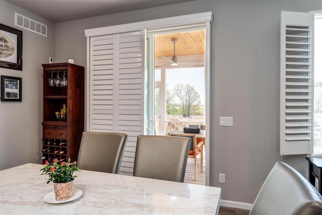 dining space with baseboards and a ceiling fan