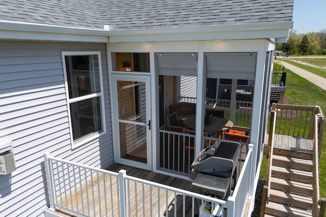 wooden terrace featuring a sunroom and stairway
