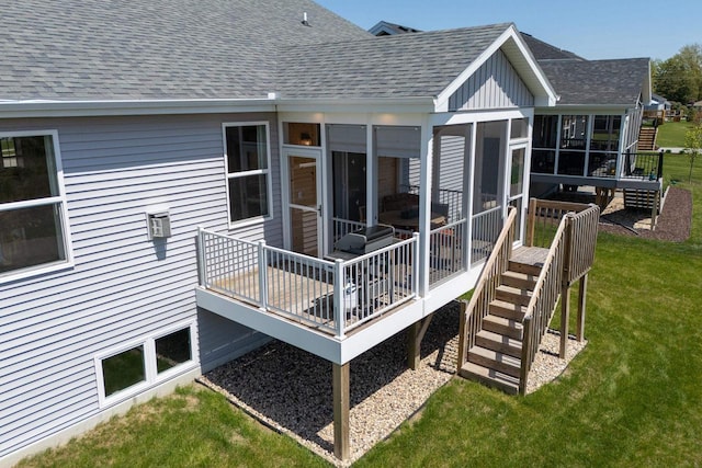 back of house featuring a sunroom, stairs, a deck, and a shingled roof