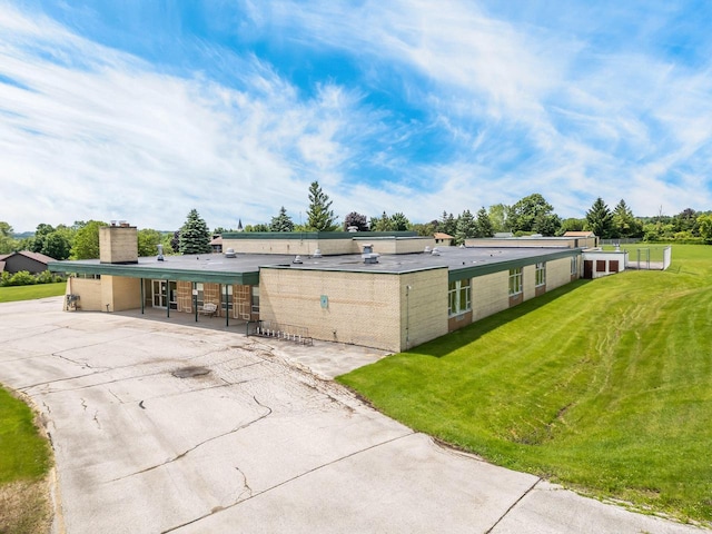 510 Lake St, Cascade, WI 53011 - rear view of house featuring a lawn, a patio area, and a chimney