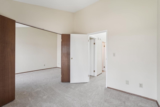 spare room featuring baseboards and carpet flooring