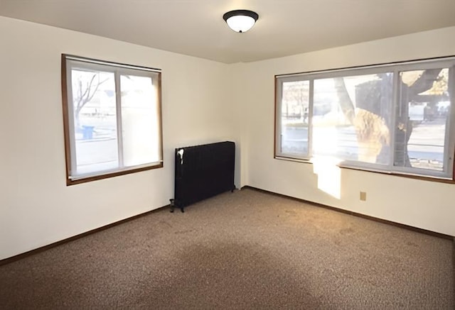 unfurnished room featuring baseboards, light carpet, and a wealth of natural light