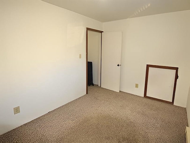 spare room featuring light colored carpet