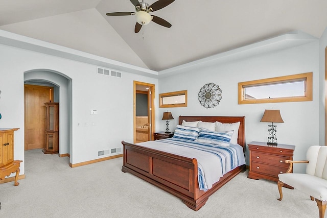 bedroom featuring vaulted ceiling, arched walkways, carpet floors, connected bathroom, and baseboards