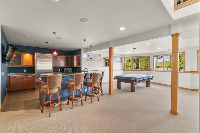 rec room with bar with sink, recessed lighting, light colored carpet, and baseboards