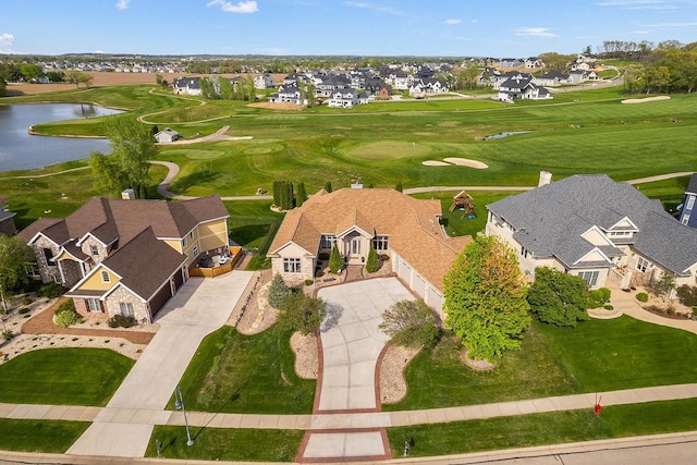 aerial view of residential area featuring a nearby body of water and a local golf course