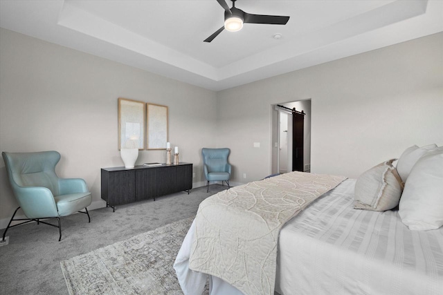 N59W27328 Autumn Ct, Lisbon, WI 53089 - carpeted bedroom featuring baseboards, a barn door, a raised ceiling, and ceiling fan