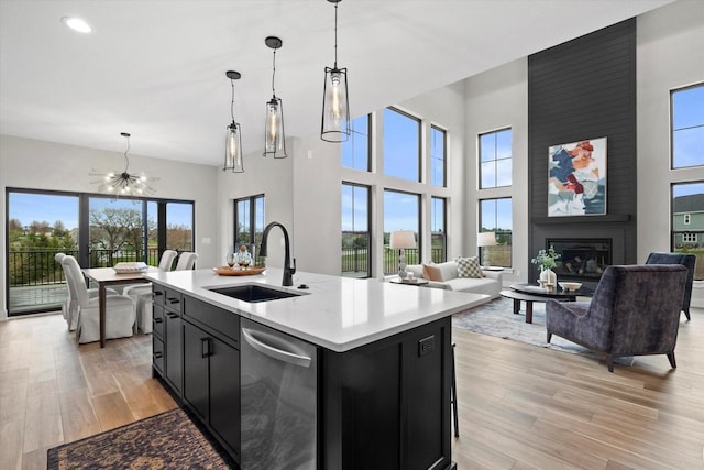 N59W27328 Autumn Ct, Lisbon, WI 53089 - kitchen featuring dark cabinets, open floor plan, a sink, and dishwasher