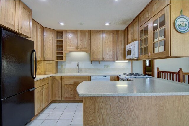 1897 Breezy Bay Rd, Balsam Lake, WI 54810 - kitchen featuring a sink, light countertops, a peninsula, white appliances, and light tile patterned flooring