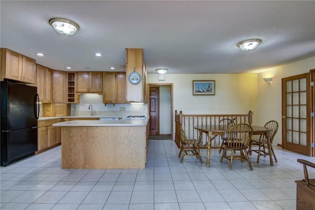 1897 Breezy Bay Rd, Balsam Lake, WI 54810 - kitchen featuring open shelves, light countertops, a textured ceiling, freestanding refrigerator, and a peninsula