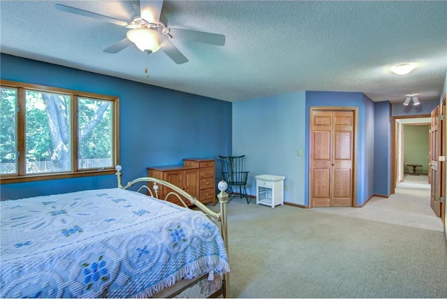 1897 Breezy Bay Rd, Balsam Lake, WI 54810 - bedroom featuring ceiling fan, light colored carpet, a textured ceiling, baseboards, and a closet