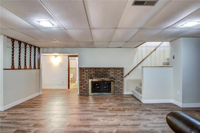 1897 Breezy Bay Rd, Balsam Lake, WI 54810 - unfurnished living room with visible vents, baseboards, wood finished floors, and stairway