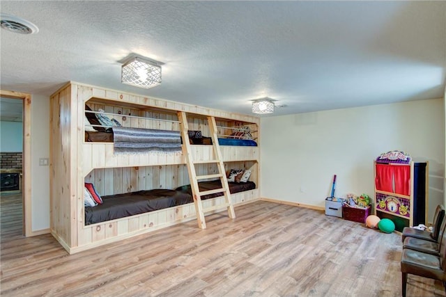 1897 Breezy Bay Rd, Balsam Lake, WI 54810 - bedroom featuring baseboards, a textured ceiling, visible vents, and wood finished floors