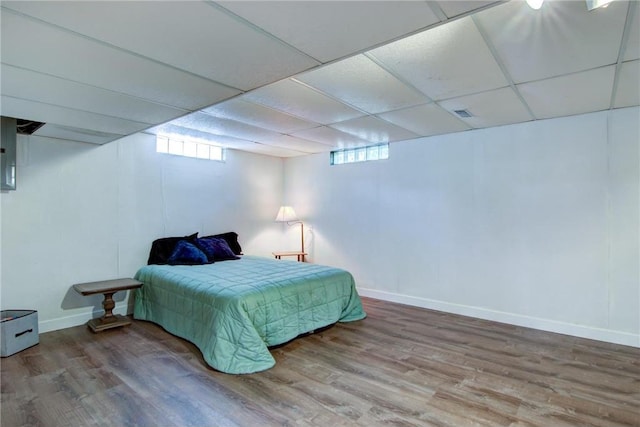 1897 Breezy Bay Rd, Balsam Lake, WI 54810 - bedroom featuring baseboards, visible vents, wood finished floors, and a paneled ceiling