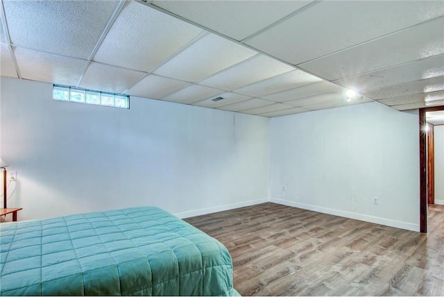1897 Breezy Bay Rd, Balsam Lake, WI 54810 - bedroom with baseboards, a drop ceiling, and wood finished floors