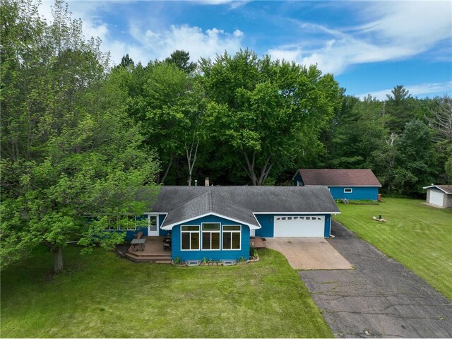 1897 Breezy Bay Rd, Balsam Lake, WI 54810 - view of front of property featuring roof with shingles, an attached garage, a front lawn, aphalt driveway, and a wooden deck