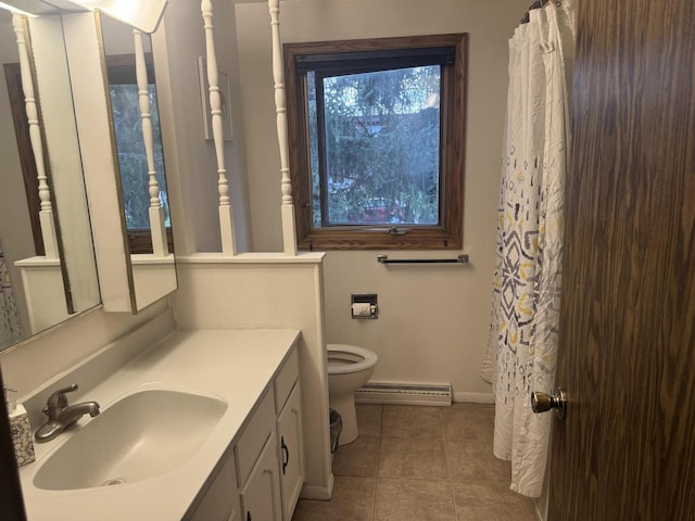 266 Forest St, Berlin, WI 54926 - full bath featuring tile patterned flooring, baseboards, a baseboard radiator, vanity, and toilet
