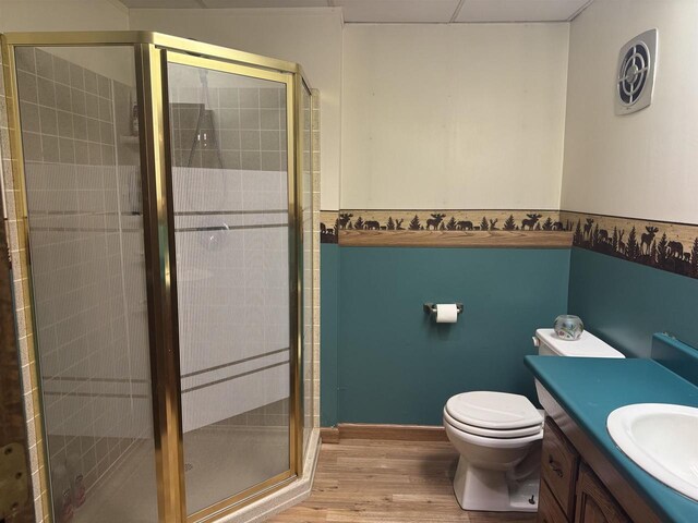 266 Forest St, Berlin, WI 54926 - full bath featuring vanity, a stall shower, toilet, and wood finished floors