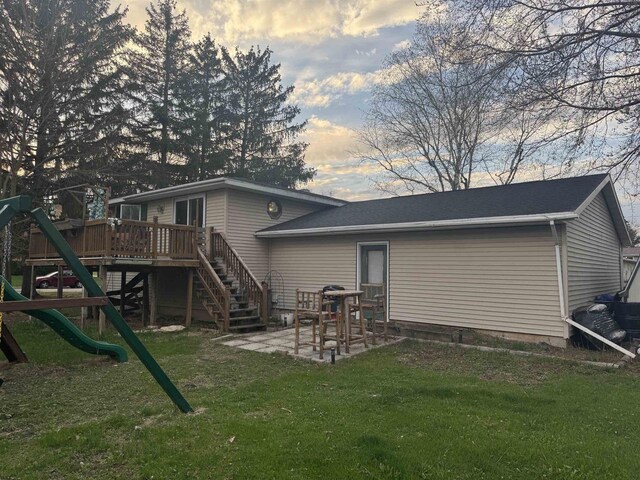 266 Forest St, Berlin, WI 54926 - rear view of property featuring a playground, a wooden deck, a lawn, and a patio area