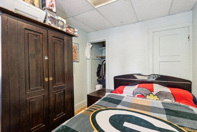 3025 W Pierce St, Milwaukee, WI 53215 - bedroom with baseboards, a closet, wood finished floors, and a paneled ceiling